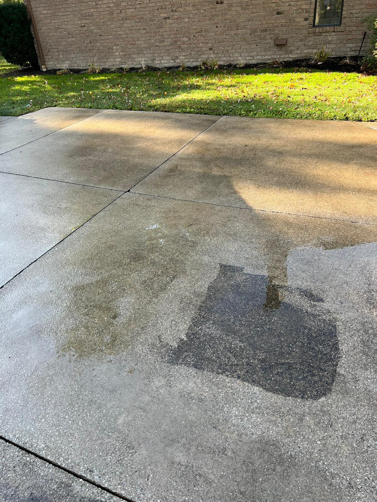 Driveway concrete showing cleaned and dirty sections