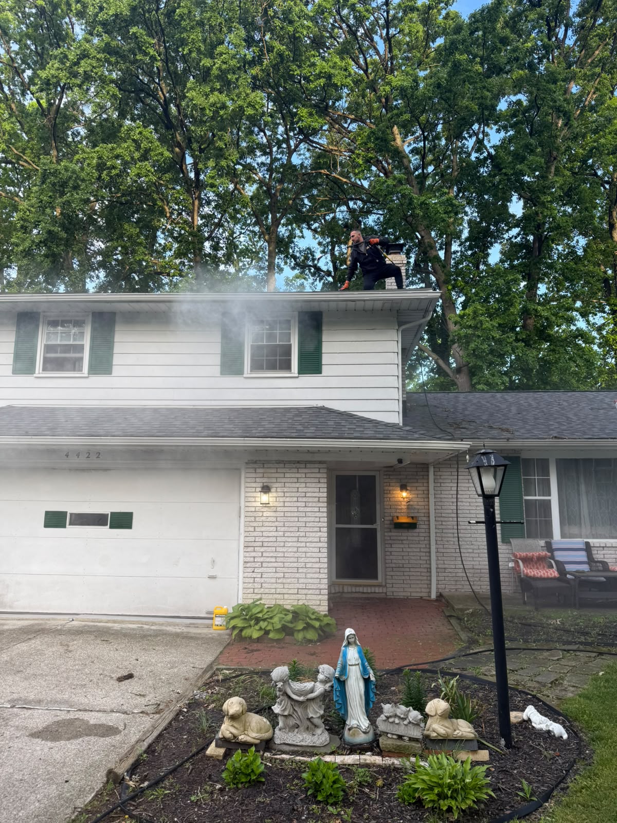 House exterior washing with mist from a pressure washer